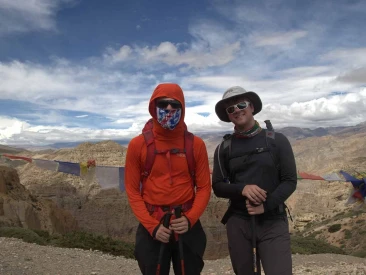 trekkers standing at a scenic high mountain pass vantage point